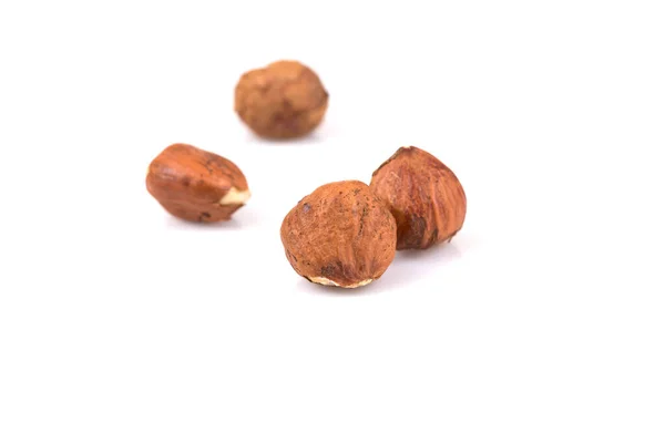 stock image Heap of hazelnuts isolated on white background, macro image