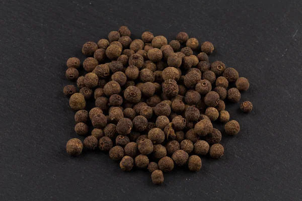 Large Black Peppercorn Seeds Dark Stone Background — Stock Photo, Image