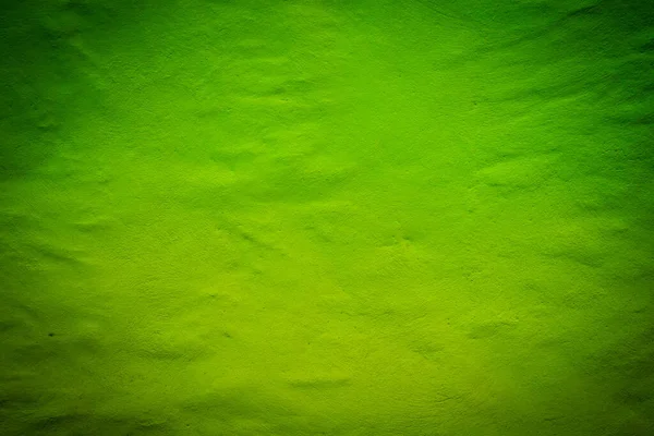 绿色暗纹理背景与明亮的中心焦点 — 图库照片