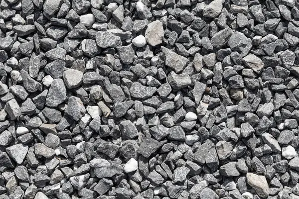 Crushed grey stone on the ground texture background