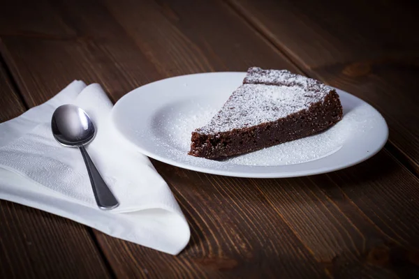 stock image Chocolate Cake Slice on white dish and wooden background