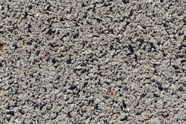 Crushed granite stones wall - close up background