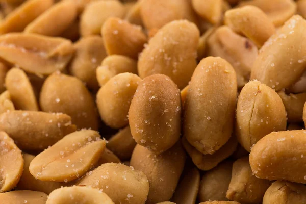 Close-up of a large amount of peeled salted peanuts in a basket