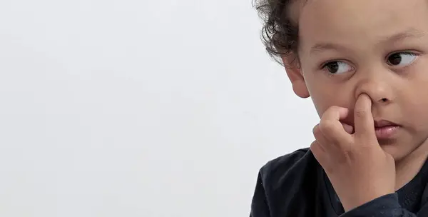 boy picking his nose with people on white background