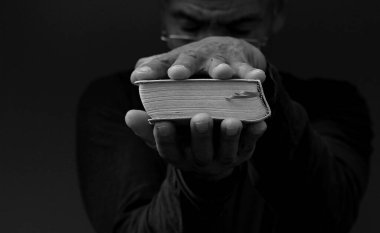 Elinde kutsal kitabı tutan adam. 