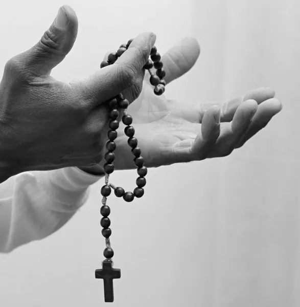 black man praying to God on grey black background