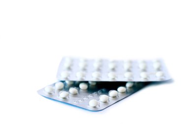 two packs of contraceptive pills on white background