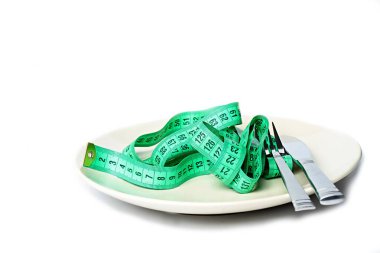 plate with measuring tape  and fork, knife, diet concept