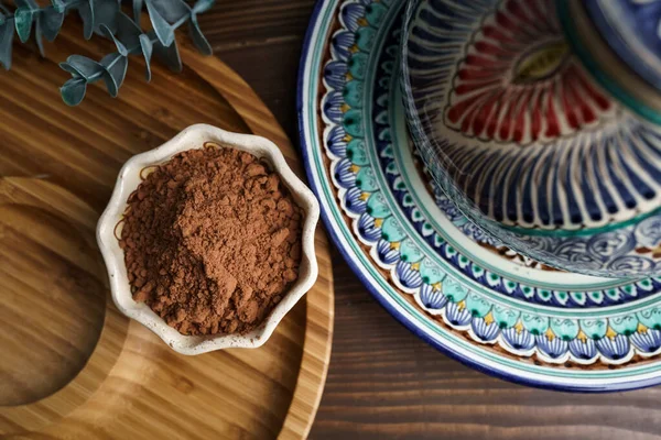 Cocoa powder in a clay bowl. Ingredients and spices for cooking.