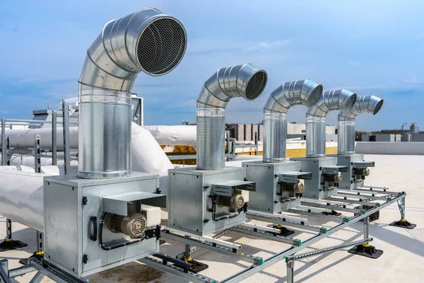 stock image The air conditioning and ventilation system of a large industrial building is located on the roof. It consists of air ducts, air conditioning, smoke removal and ventilation