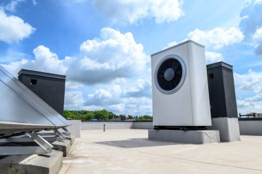 Isı pompası ve güneş enerjisi toplayıcısı evin çatısında. Suyu ısıtmak için alternatif enerji kaynağı kullanan bir sistem.