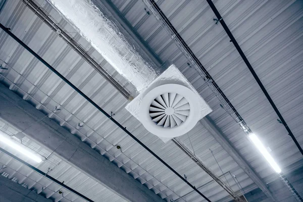 大仓库天花板上的通风系统 新大楼的天花板上挂着用银绝缘材料做的管子 — 图库照片