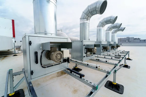 stock image The air conditioning and ventilation system of a large industrial building is located on the roof. It consists of air ducts, air conditioning, smoke removal and ventilation