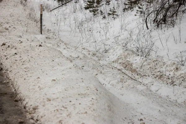 Yolun kenarında kar var.