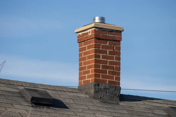 a chimney on the roof of a residential building