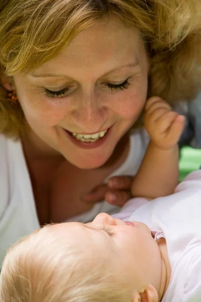Young Woman Playing Her Month Old Daughter Stock Photo