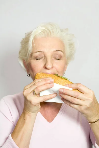 Woman Biting Sausage Baguette — Stock Photo, Image