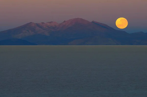 Full moon setting at dawn, Salar de Uyuni, Uyuni, Potosi, Bolivia, South America