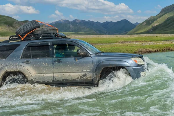 Four-Wheel Drive crossing a river, Kurumduk valley, Naryn province, Kyrgyzstan, Asia