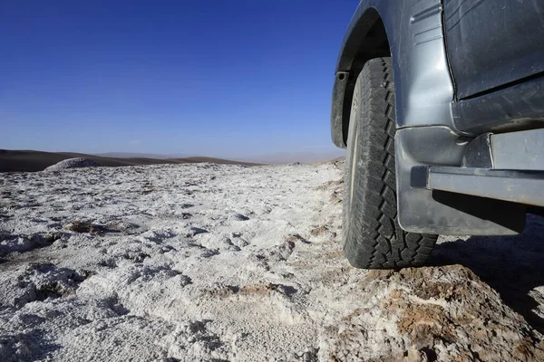 Off-road vehicle on the road in the valley of the moon, Valle de la Luna, San Pedro de Atacama, Antofagasta, Chile, South America