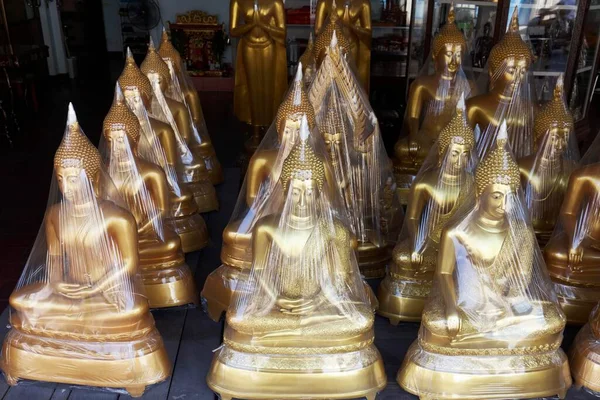 stock image Buddha statues in foil, for sale, devotional business in the Buddha Road, Thanon Bamrung Meuang, Phra Nakhon, Bangkok, Thailand, Asia