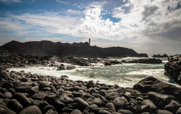 黒溶岩石とビーチ ターコイズブルーの海 バック灯台プンタ テノで テネリフェ島 カナリア諸島 スペイン ヨーロッパ — ストック写真