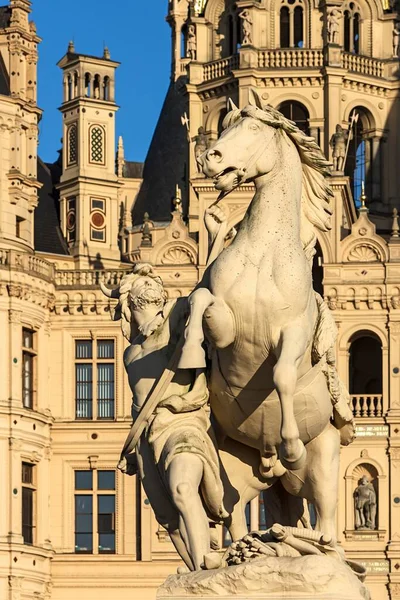 Obotrite tames his horse, sculpture by Christian Genschow circa 1873, castle bridge in front of the Schwerin Castle in the evening light, Schwerin, Mecklenburg-Vorpommern, Germany, Europe