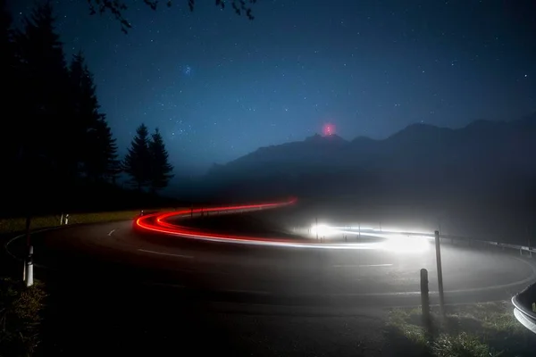 Pass road with cars to Schwgalp with stars and Milky Way, light traces, Schwgalp, Urnsch, Appenzell Ausserrhoden, Switzerland, Europe