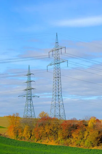 Electric overhead power pole in the field, power poles in the field, power lines, overhead power line, supply lines, electrosmog, environmental pollution, power poles, electricity pylons, energy suppliers, EnBW, Vattenfall, Eon, RWE, fieldscape