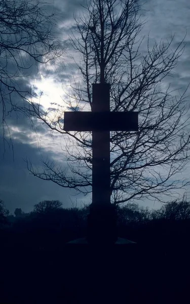 Grave cross in the cemetery, evening mood