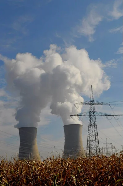 NUCLEAR POWER PLANT. Grafenrheinfeld nuclear power plant near Schweinfurt, high-voltage lines, power pylons, cooling tower with steam cloud