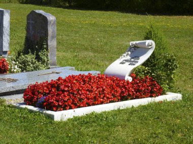 Baden, Wuerttemberg, Hohenlohe Graves at the cemetery in Weipertshofen, begonias at the grave clipart