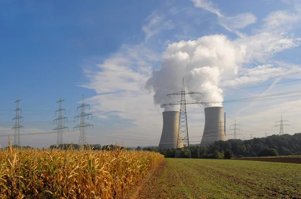 NUCLEAR POWER PLANT. Grafenrheinfeld nuclear power plant near Schweinfurt, high-voltage lines, power pylons, cooling tower with steam clouds