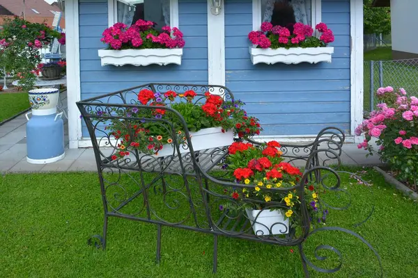 Czerwone Pelargonie Kwitnące Pudełku Przy Ogrodzie Kute Żelazne Sanie Kwiatami — Zdjęcie stockowe