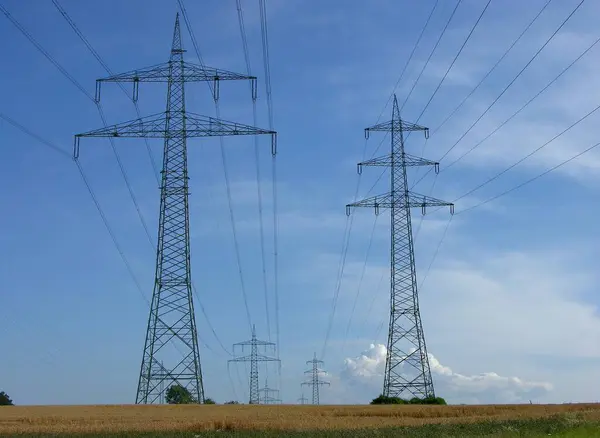 Power pylons in the field, power lines, overhead line, supply lines, electrosmog, environmental pollution, high voltage, power pylons, energy suppliers, EnBW, Vattenfall, Eon, RWE, fieldscape -