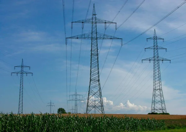 Power pylons in the field, power lines, overhead line, supply lines, electrosmog, environmental pollution, high voltage, power pylons, energy suppliers, EnBW, Vattenfall, Eon, RWE, fieldscape -