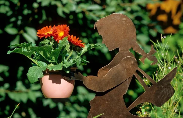 Girl figure with red Gerbera, Garden figure with flower pot, Girl plastics with red Gerbera figure with flower pot