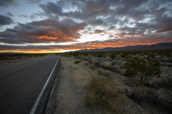 Dramatic sunset over desert landscape, country road, sunset, Mojave desert, Mojave National Preserve, California, USA, North America