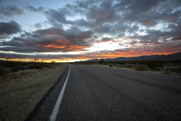 Dramatic sunset over desert landscape, country road, sunset, Mojave desert, Mojave National Preserve, California, USA, North America