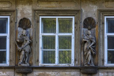 Wooden sculptures of Emperor Heinrich II and Empress Kunigunde on a facade of a house between windows, Bamberg, Upper Franconia, Bavaria, Germany, Europe clipart