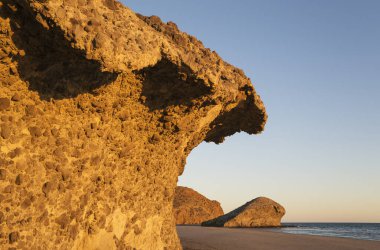 Fossilized lava tongues and walls at the beach Playa del Monsul, Nature Reserve Cabo de Gata-Nijar, Almeria province, Andalusia, Spain, Europe clipart