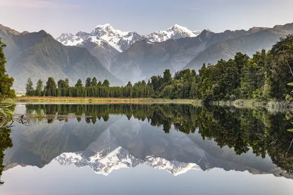 stock image View of snow-covered Mount Cook and Mount Tasman, reflection in Lake Matheson, Westland National Park, Southern Alps, West Coast Region, South Island, New Zealand, Oceania