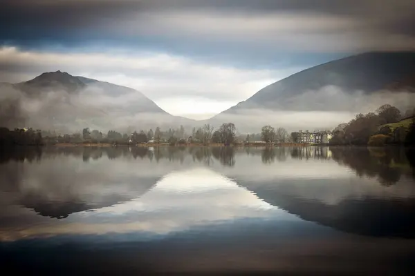 stock image Hilly landscape with trees reflected in water surface, fog, Rydal Water, Ambleside, Lake District National Park, Central England, Great Britain