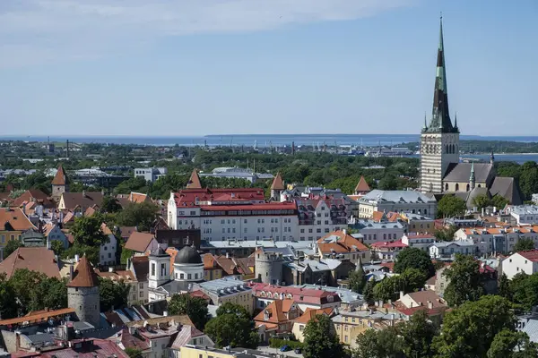 stock image City view with St Olaf's Church or Oleviste Kirik and harbour at the Baltic Sea, seen from the tower of Toomkirik Cathedral, Tallinn, Estonia, Europe