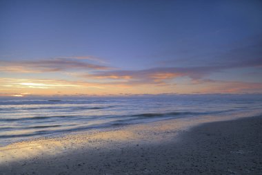 Sunset at the beach of the North Sea, Texel, North Holland, Netherlands clipart