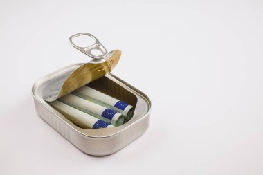 Three rolled-up 100 Euro banknotes inside a silver aluminum can on white background, Germany, Europe clipart