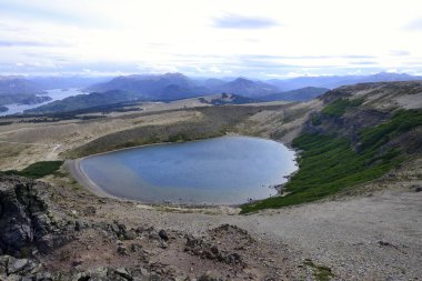 Crater lake on the volcano Batea Mahuida, behind the Lago Alumin, near Villa Pehuenia, Province of Neuqun, Argentina, South America  clipart