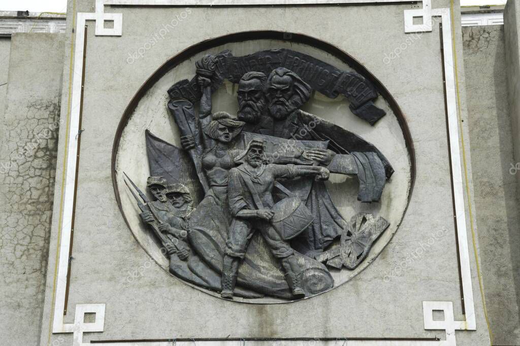 Socialistic emblem with the banner Proletarier aller Lnder vereinigt Euch and Marx and Lenin at the building at the Liberty Square Ulan Bator Mongolia