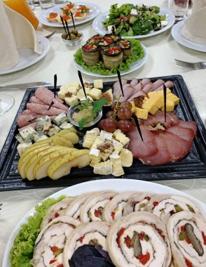 banquet table setting with appetizers, plates, glasses