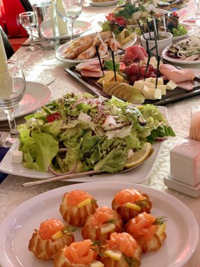 banquet table setting with appetizers, plates, glasses